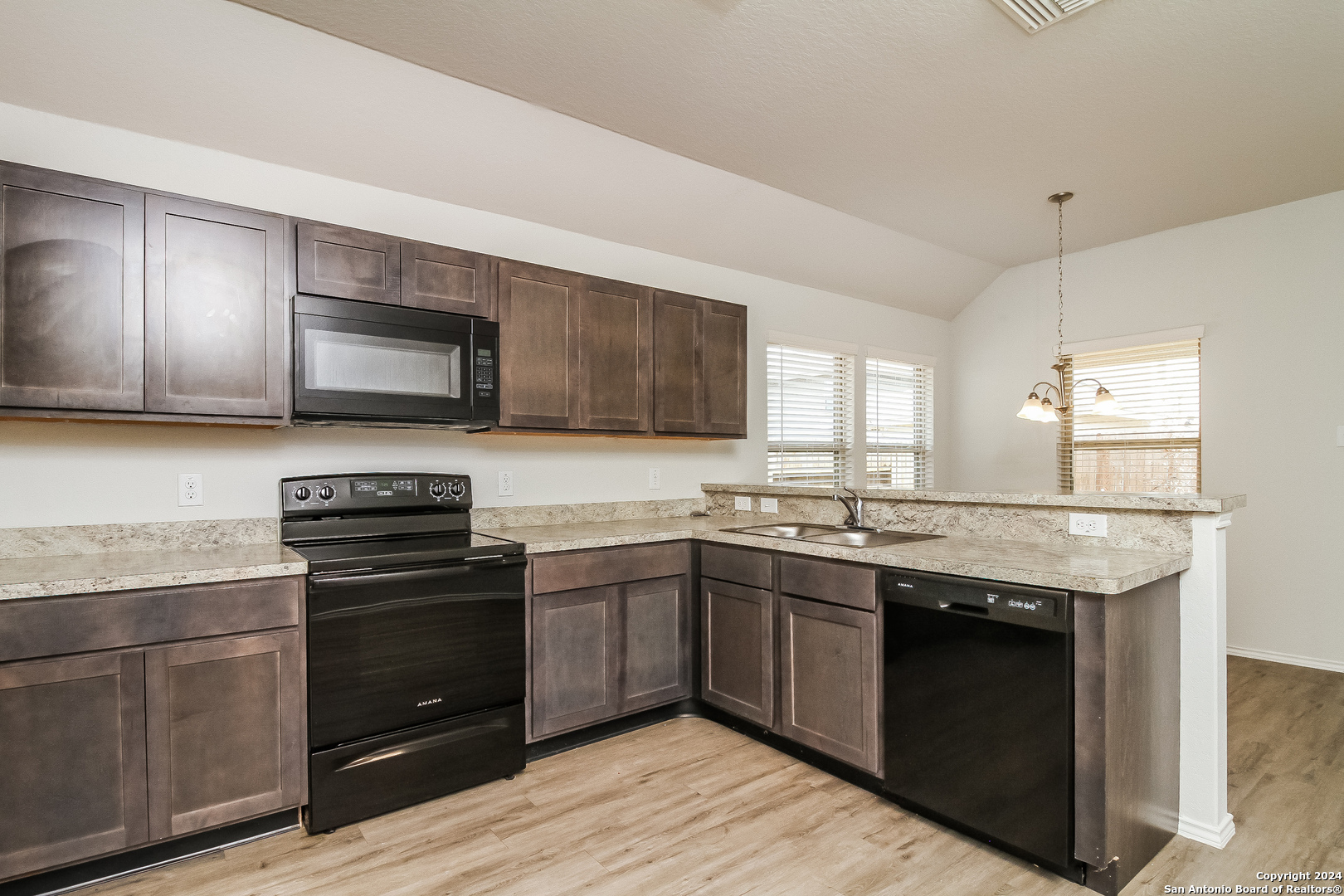 a kitchen with a sink stove and microwave