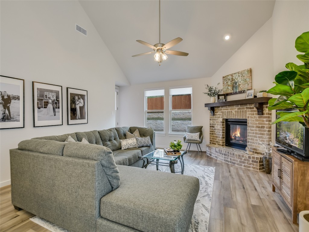 a living room with furniture a fireplace and a flat screen tv