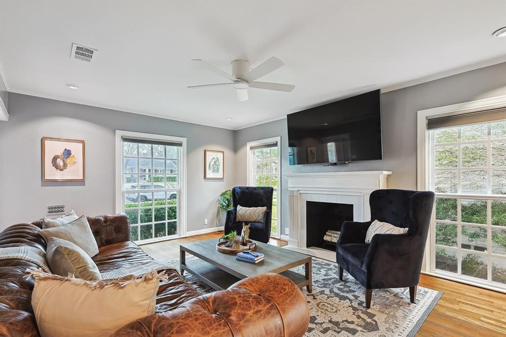 a living room with furniture a fireplace and a flat screen tv