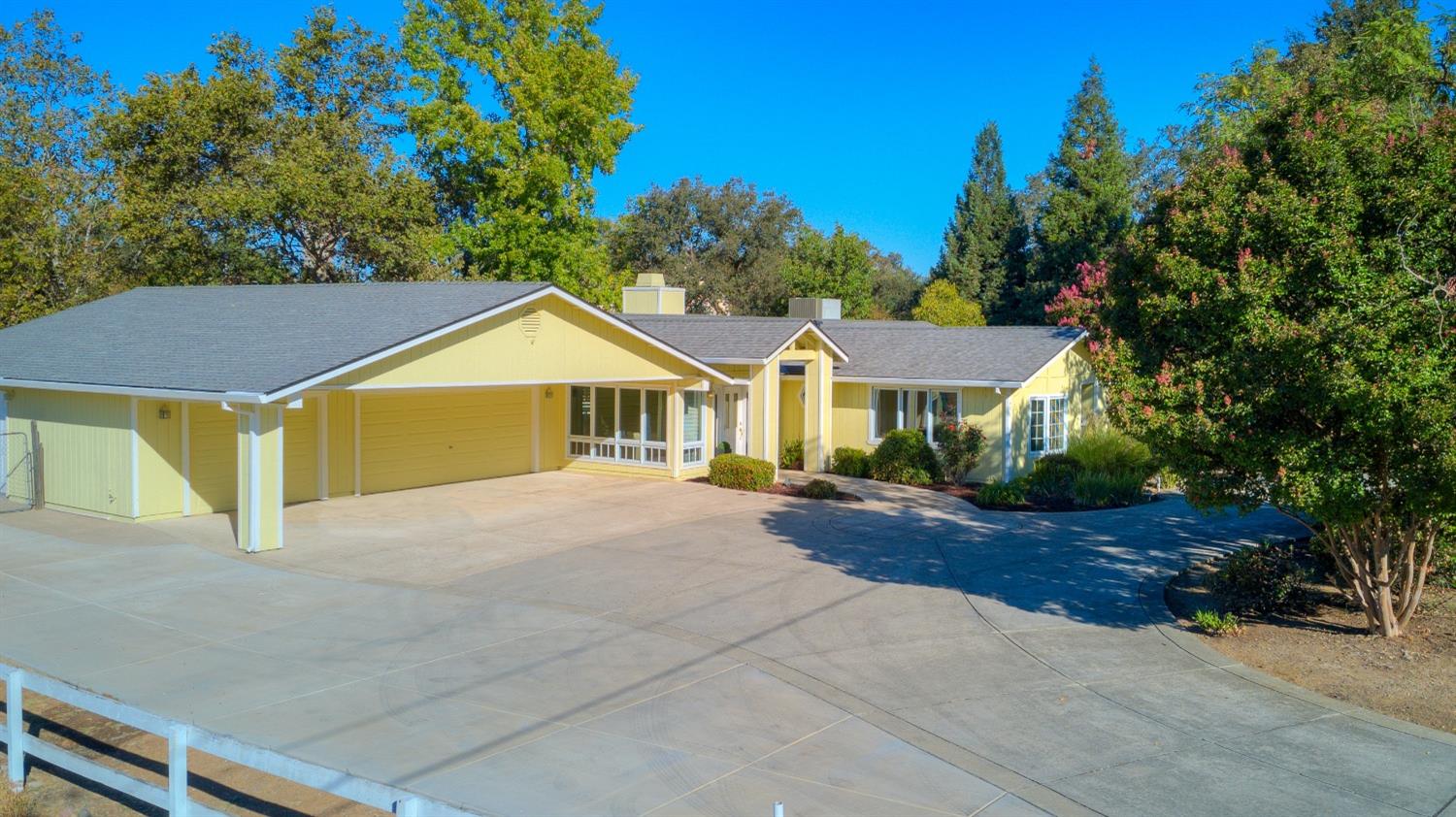 a view of a house with a yard and a garage