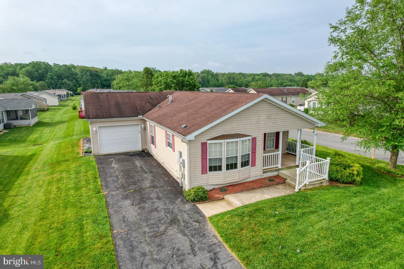 a aerial view of a house with a yard table and chairs