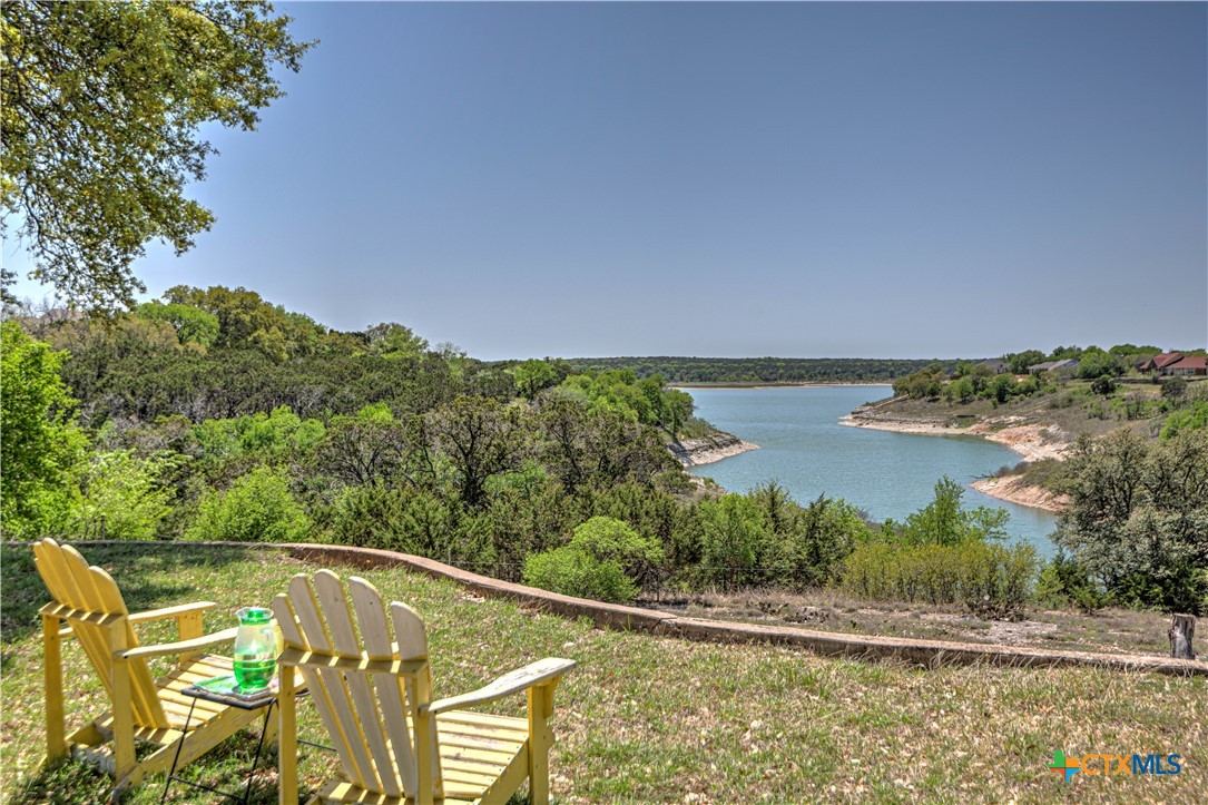 a view of a swimming pool with an outdoor seating and a lake view