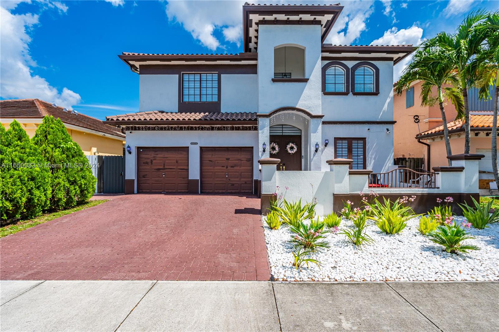 a front view of a house with a yard and a garage