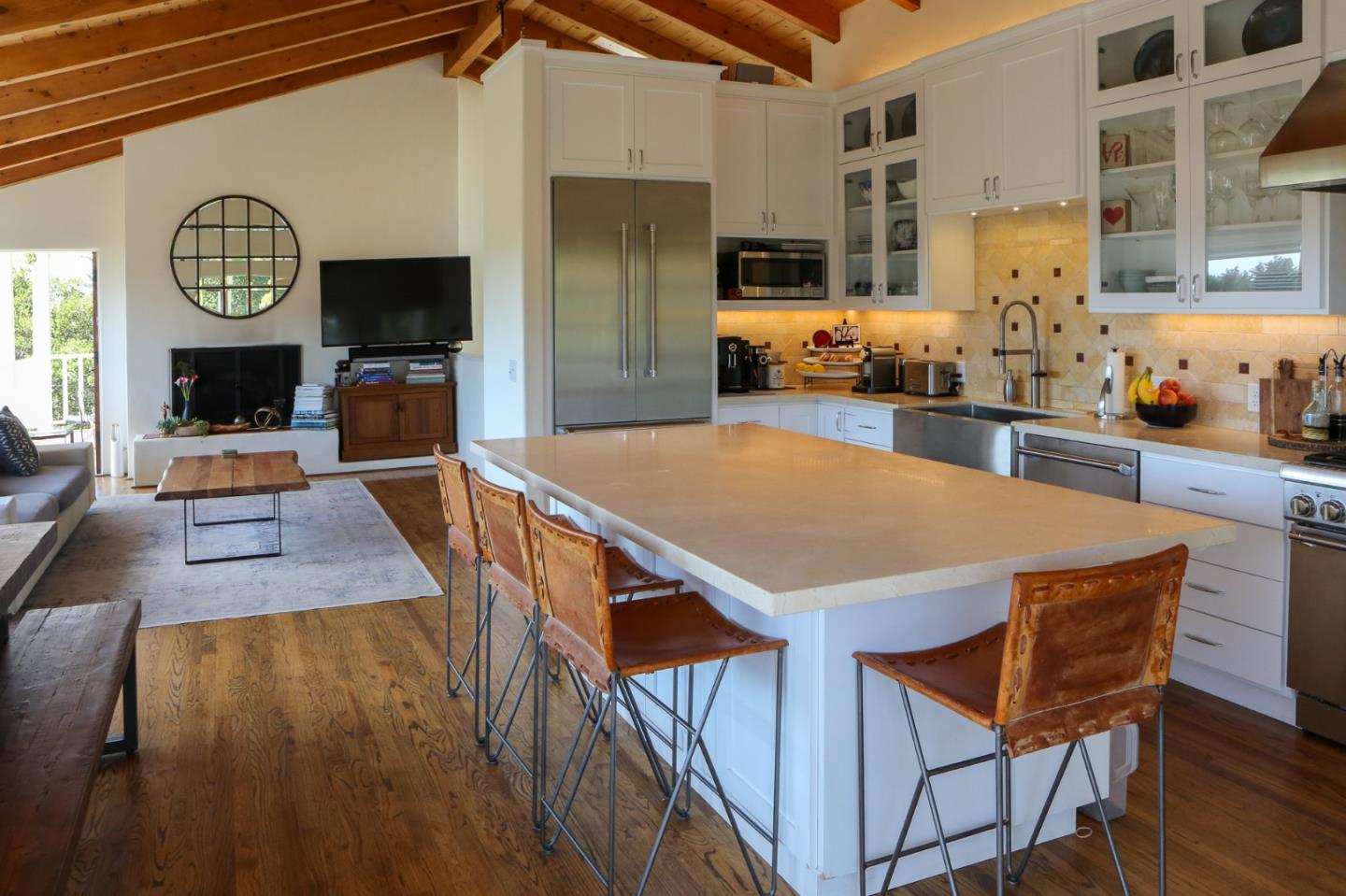 a view of a dining room with furniture and a kitchen