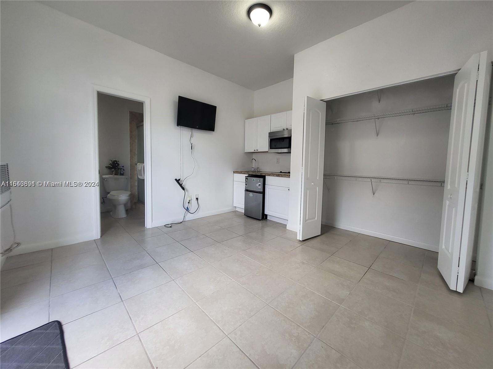 a view of a kitchen with refrigerator and sink