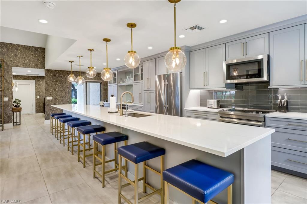 a large kitchen with a table and chairs