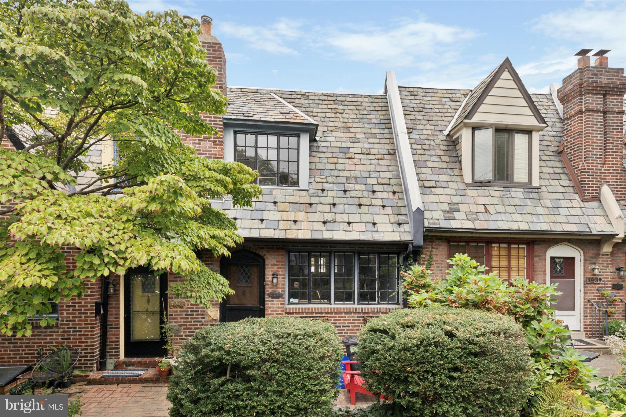 front view of a brick house with a small yard