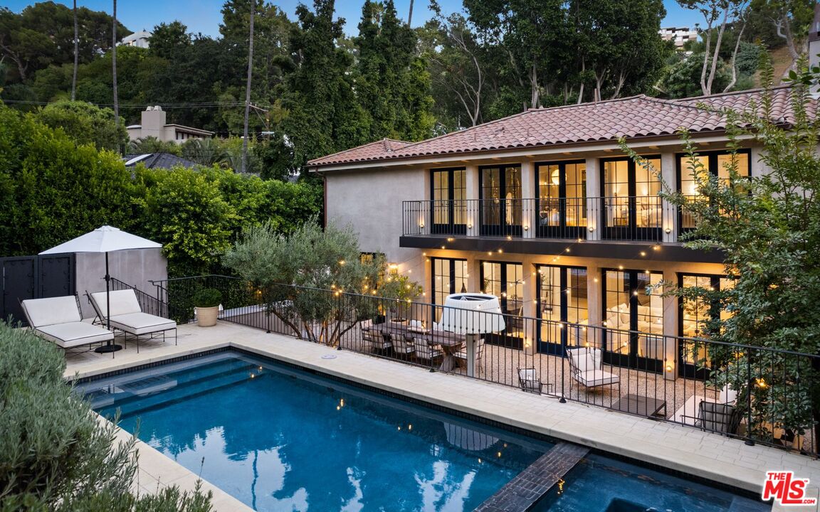 a view of swimming pool with outdoor seating and plants