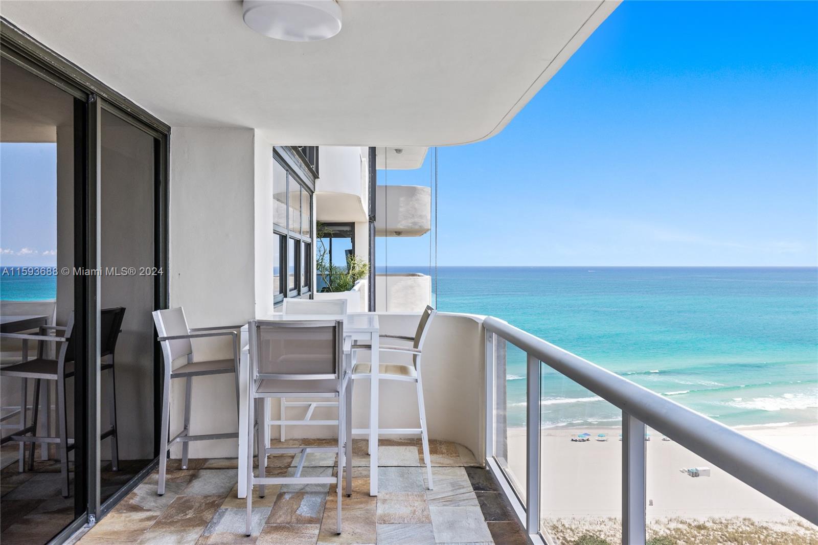 a balcony with table and chairs