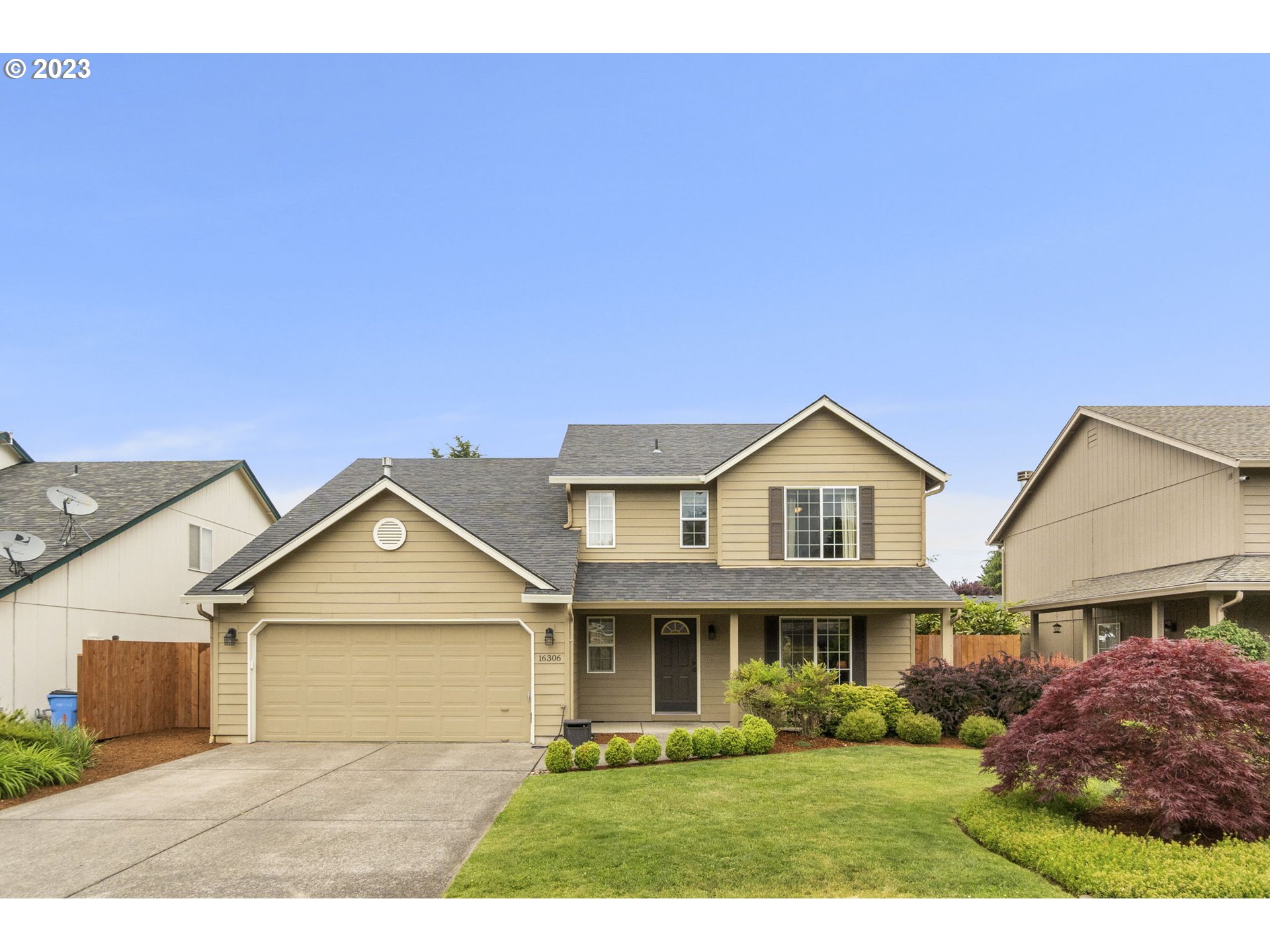 a front view of a house with a yard and garage