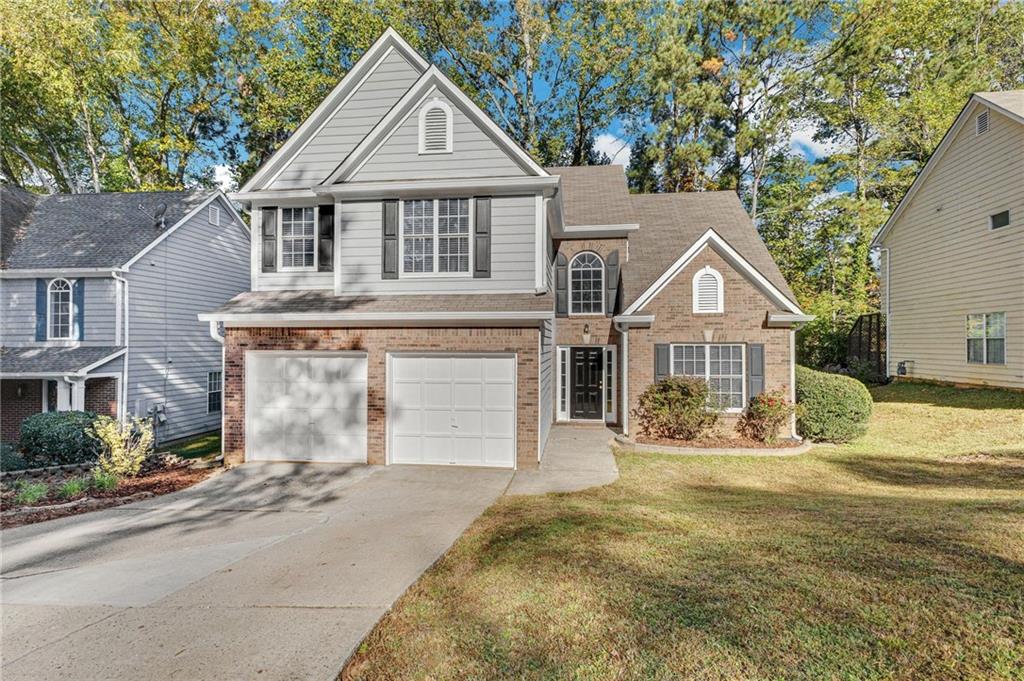 a front view of a house with a yard