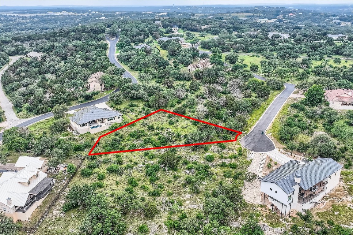 an aerial view of residential houses with outdoor space and swimming pool