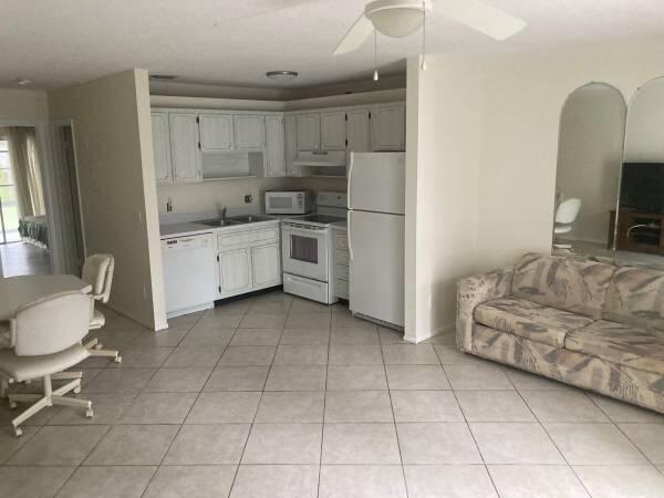 a kitchen with a sink a stove and a refrigerator