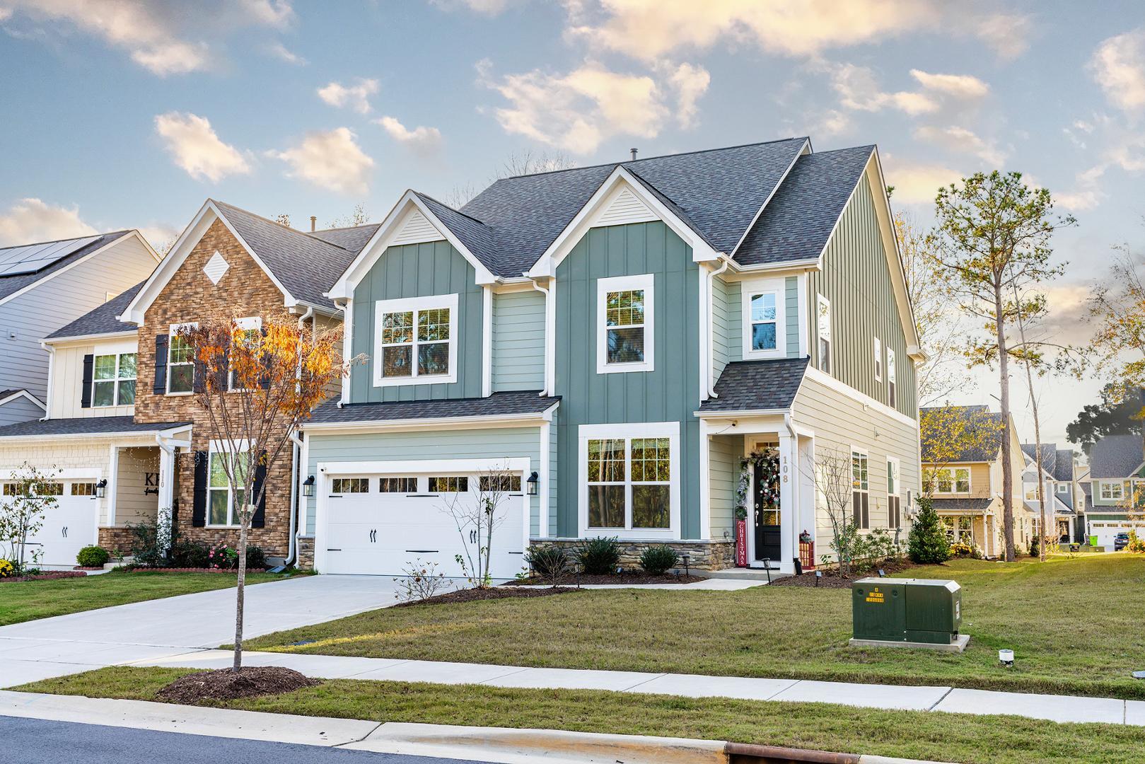 a view of a big house in a big yard next to a road