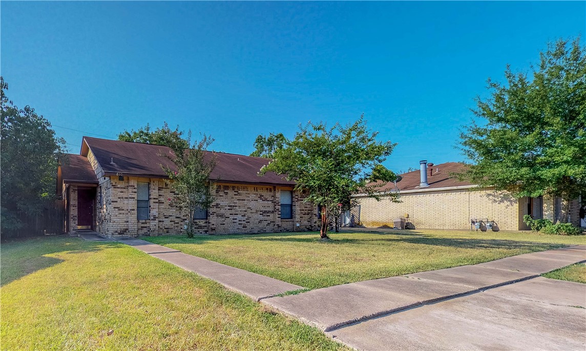 Ranch-style home featuring a front yard