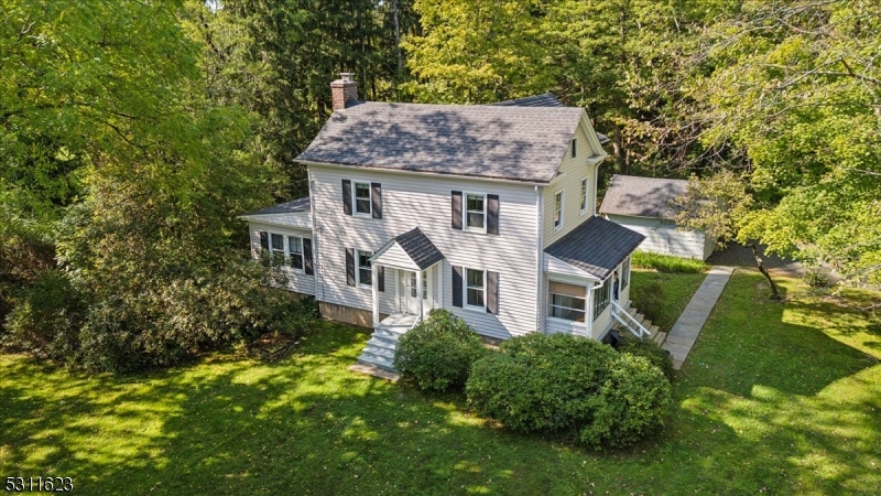 an aerial view of a house with garden space and sitting area