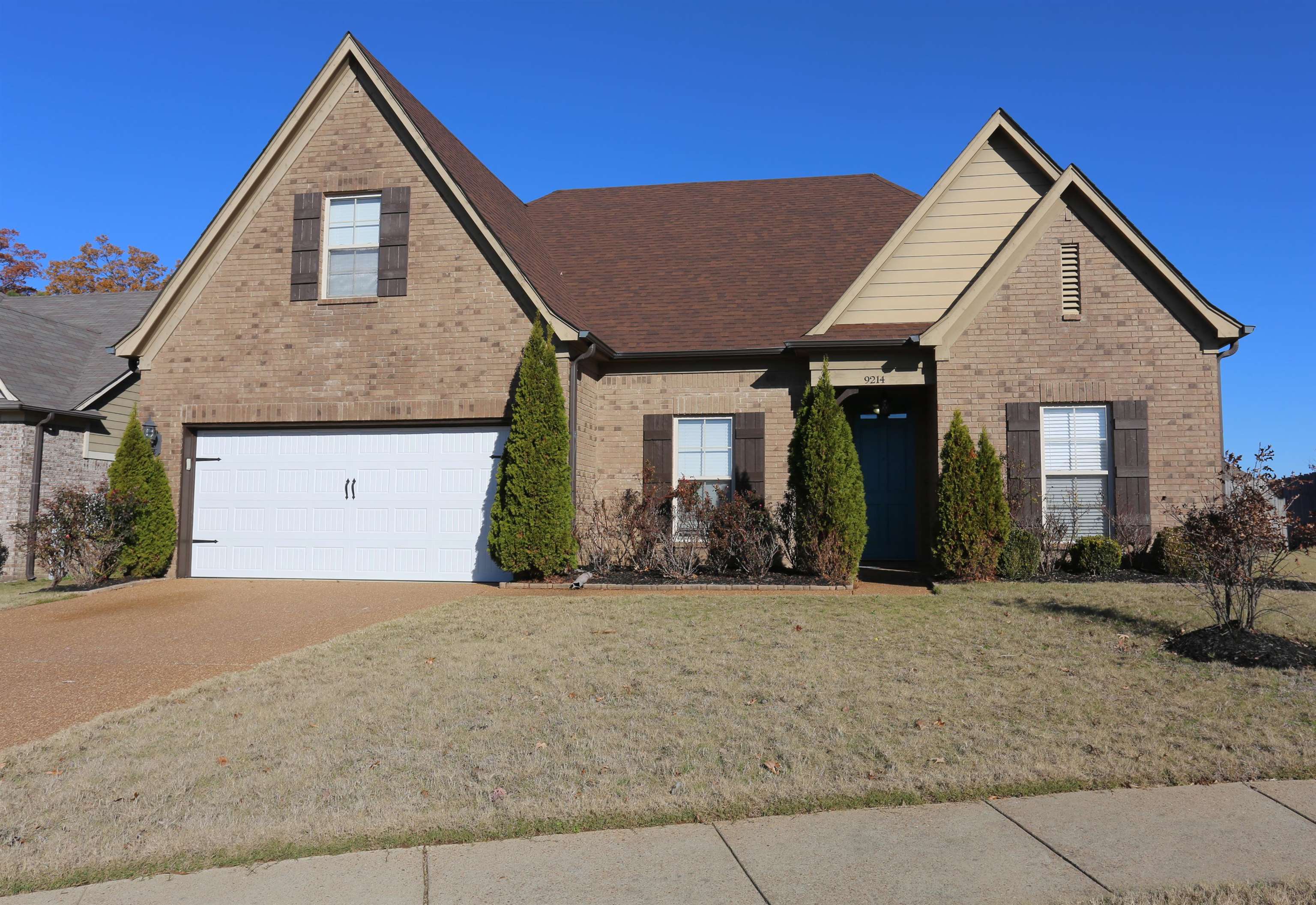 View of front of house with a garage and a front lawn