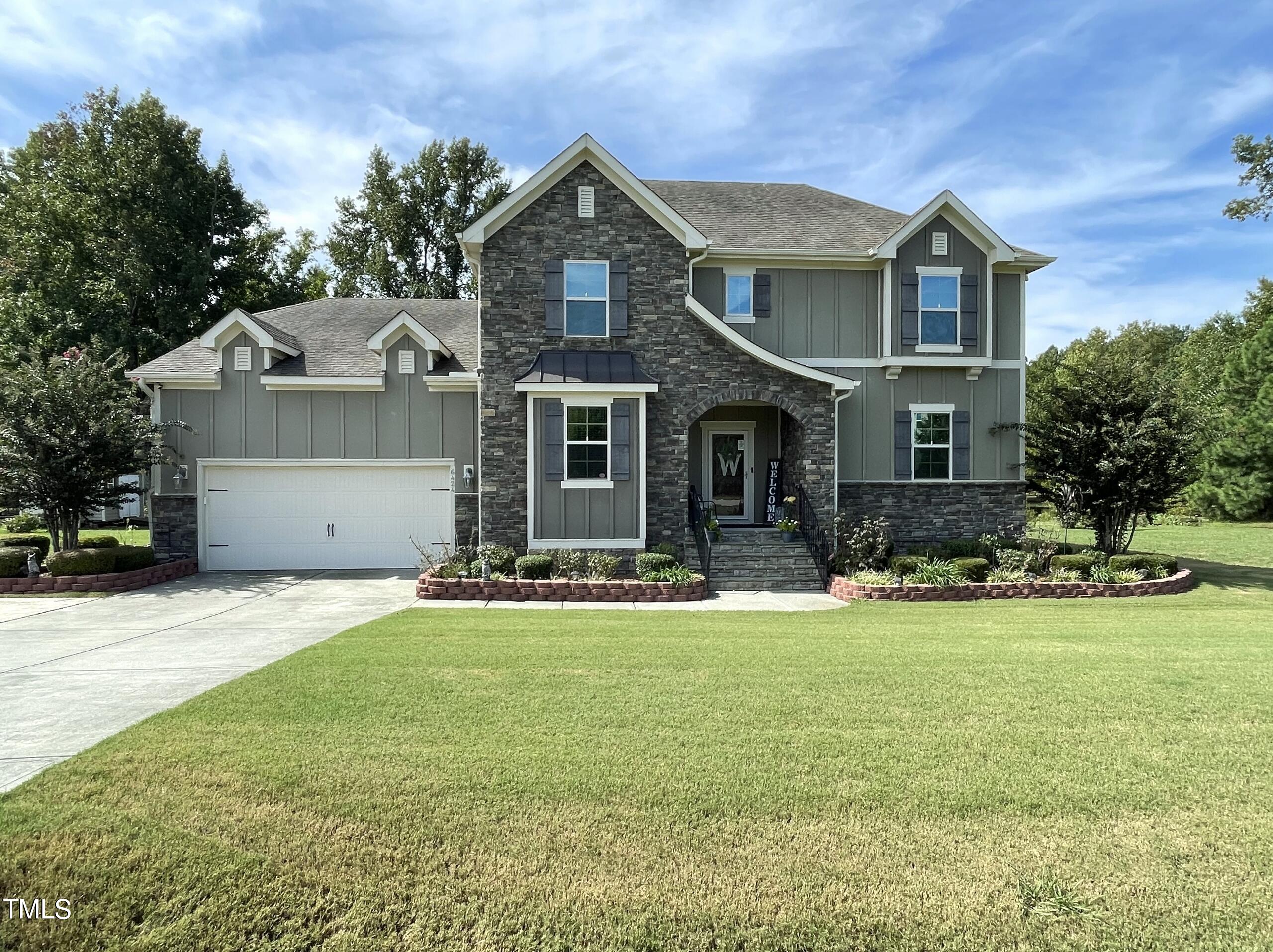 a front view of a house with a garden and porch