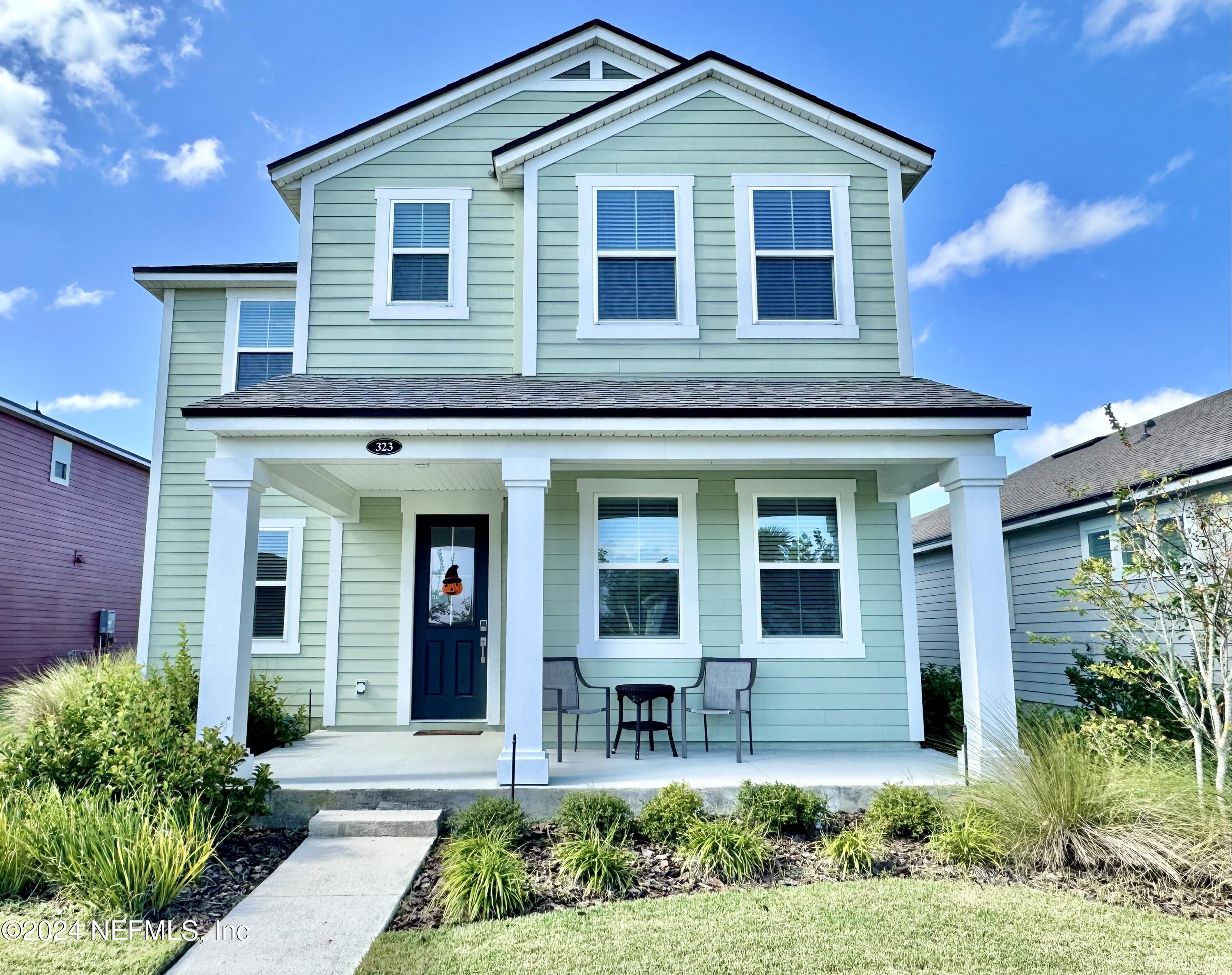 a front view of a house with garden and porch