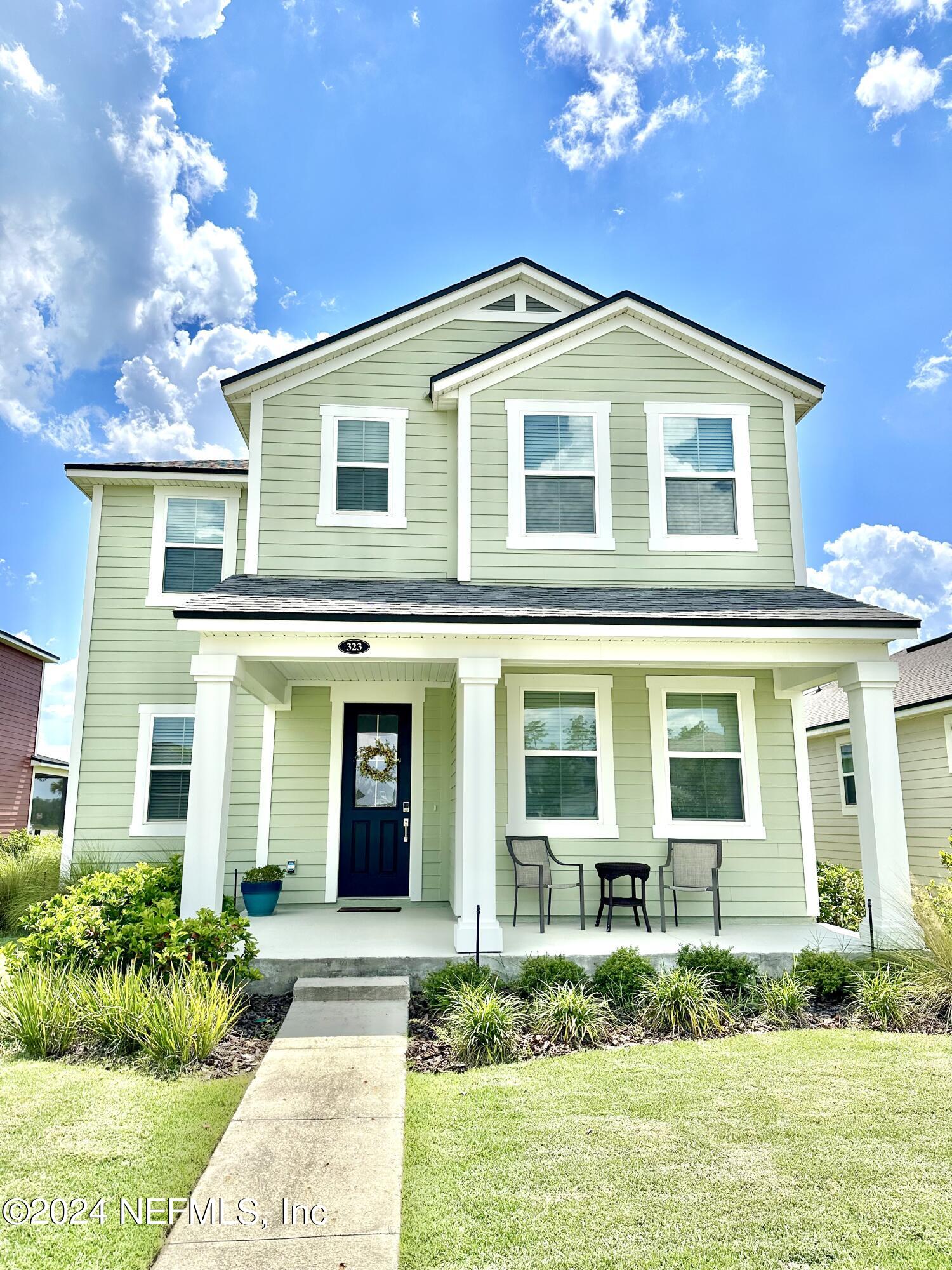 a front view of a house with garden