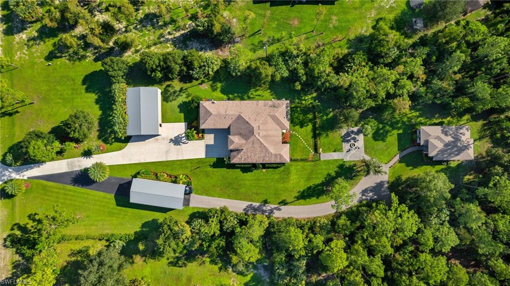 an aerial view of a house with yard swimming pool and outdoor seating