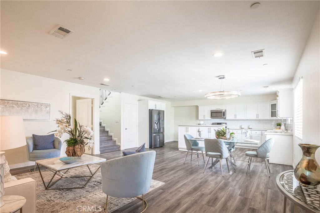 a living room with furniture and kitchen view