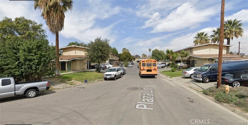 a view of a cars park in front of a house