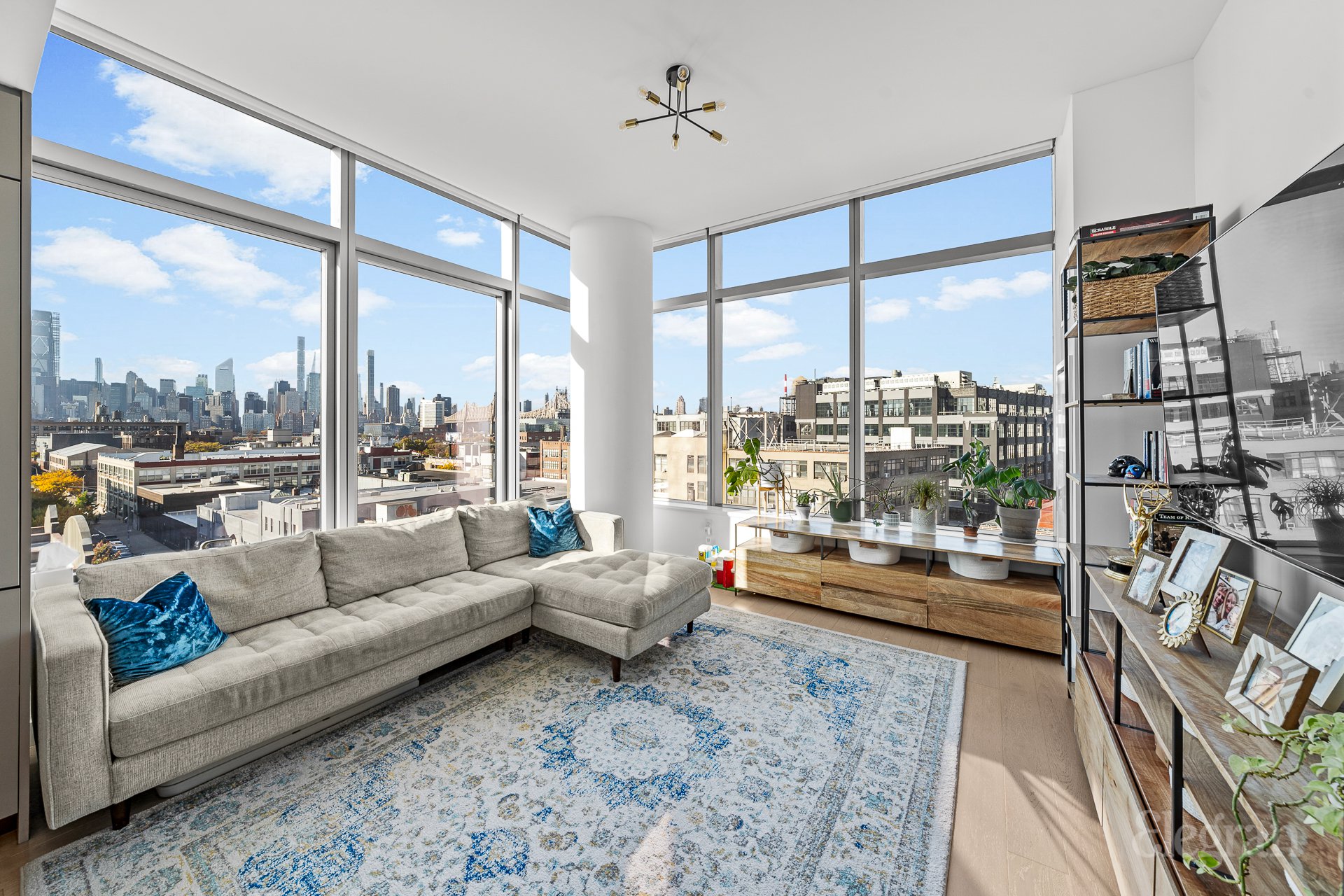 a living room with furniture and a floor to ceiling window