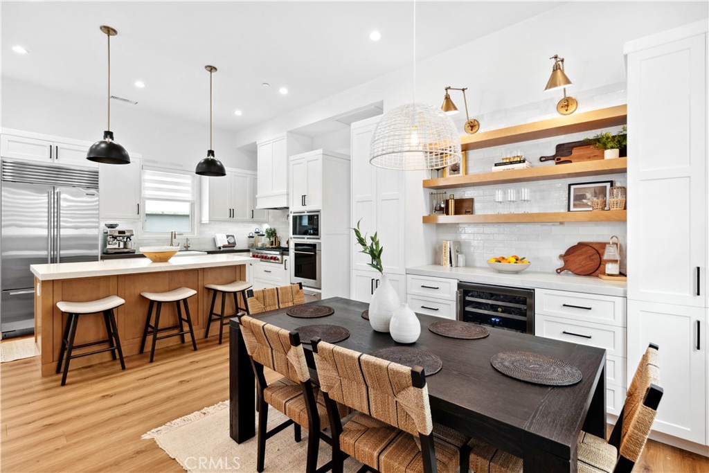 a large kitchen with a table and chairs