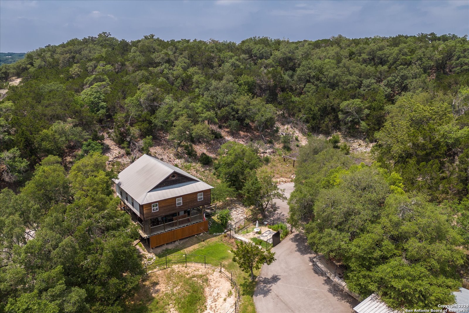 an aerial view of a house with a yard