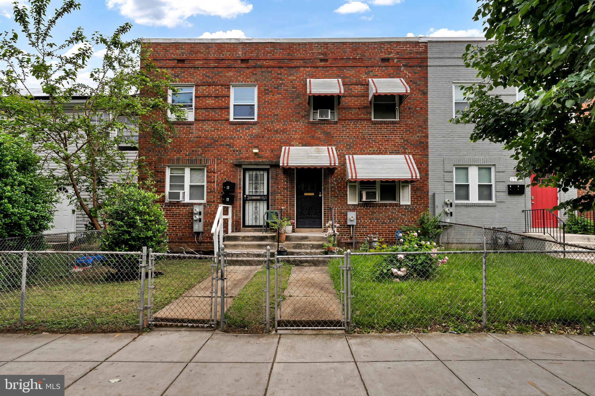 a view of house with a yard and sitting area