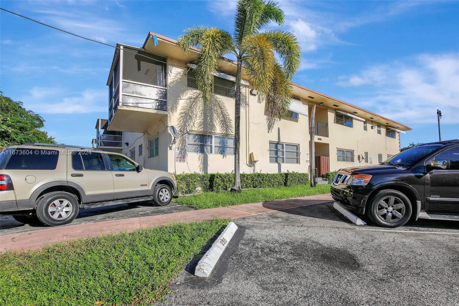 a front view of a house with a garden and parking space