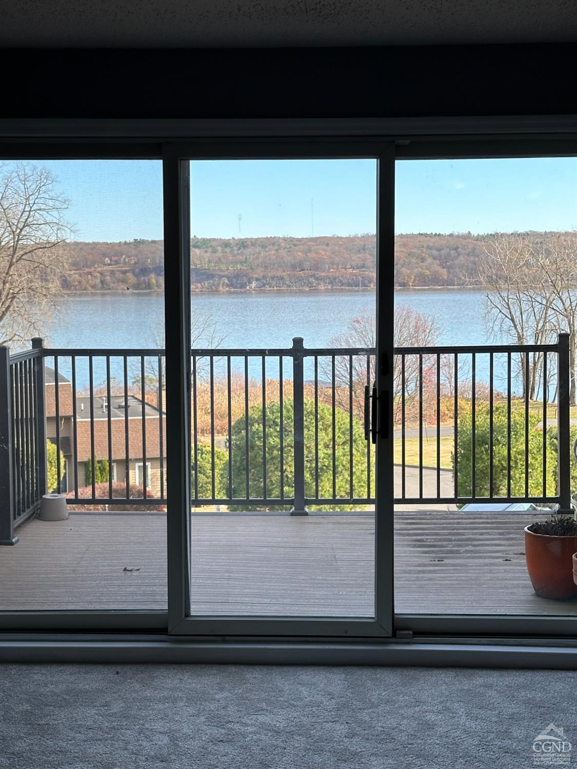 a view of a balcony with a floor to ceiling window next to a yard