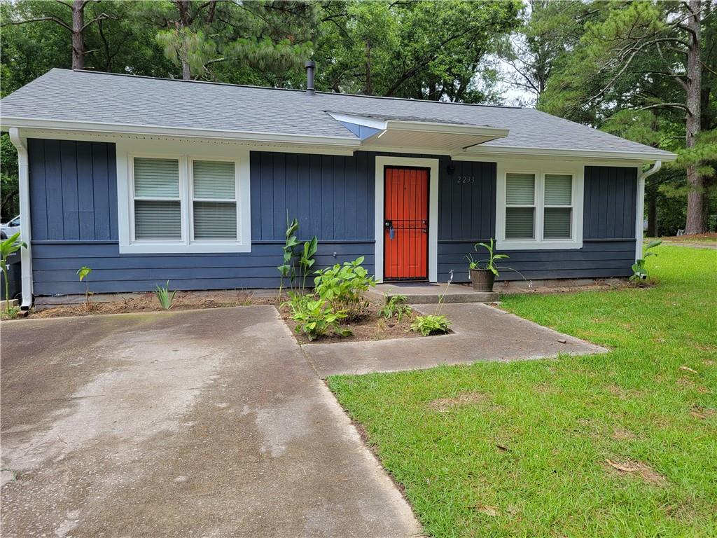 a front view of a house with a yard and porch