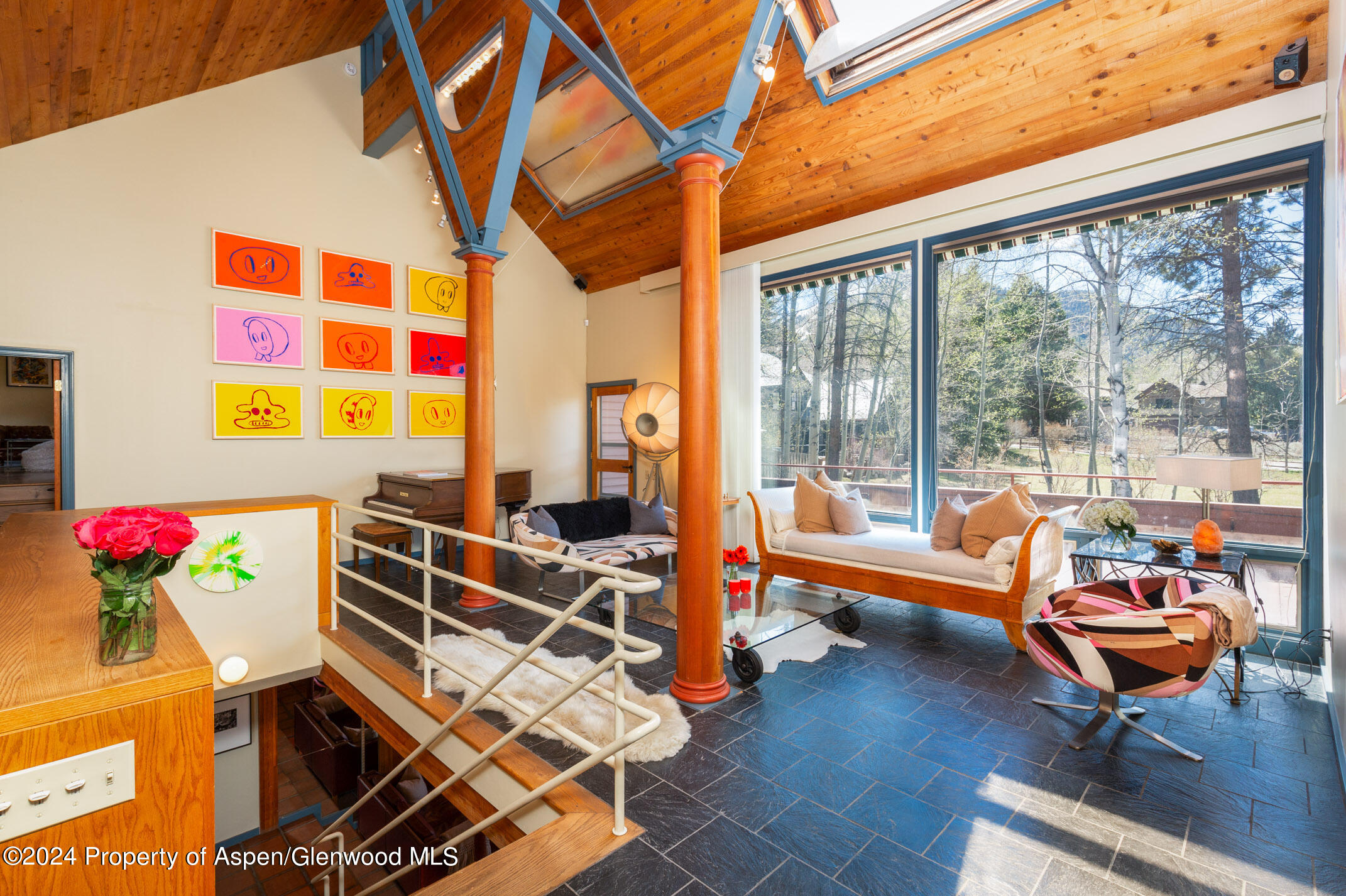 a living room with patio furniture and a floor to ceiling window