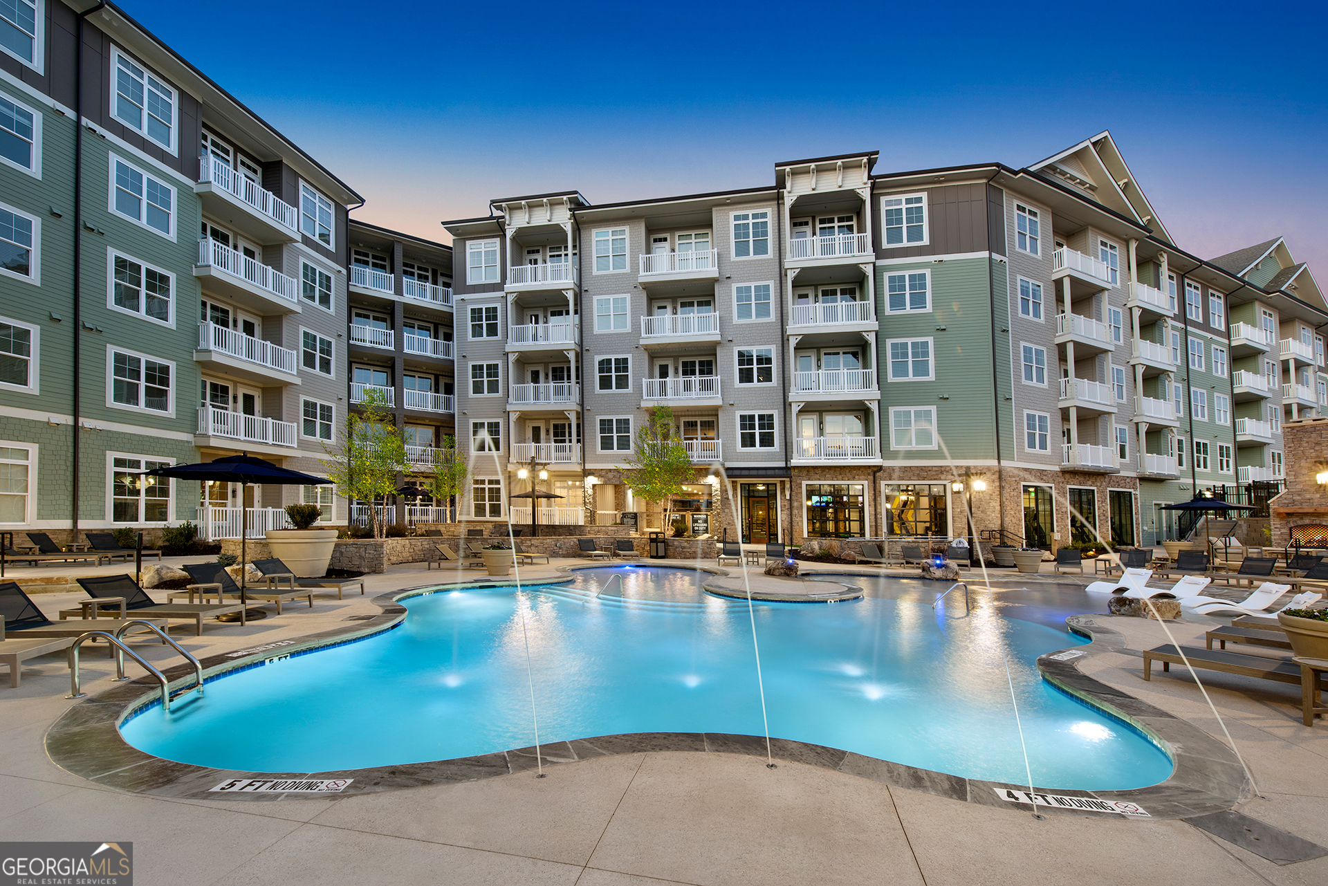 a view of tall building with pool and chairs