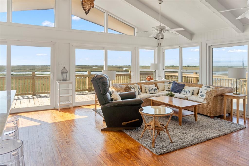 a living room with fireplace furniture and large windows