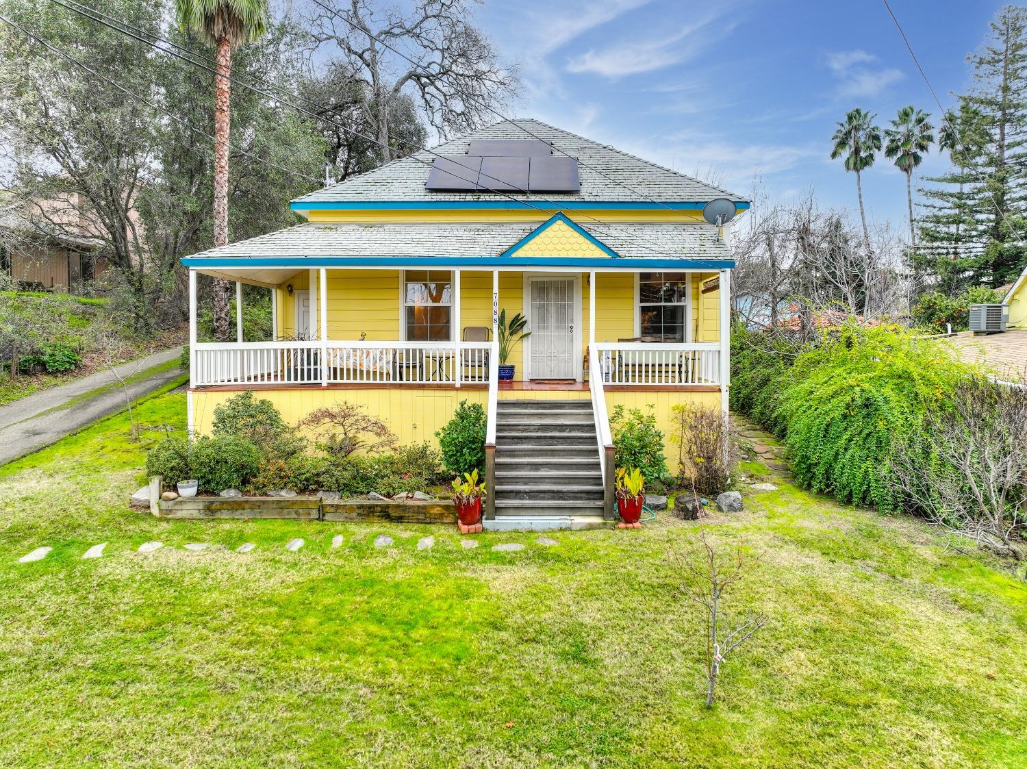 a front view of house with yard and swimming pool