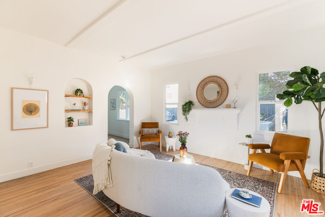 a living room with furniture and a clock