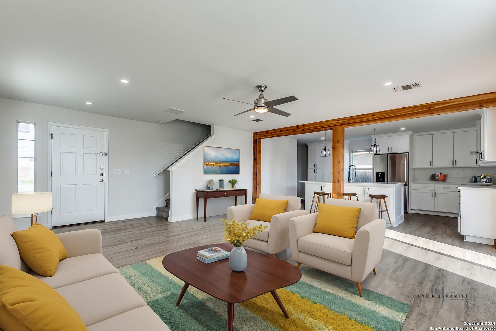 a living room with furniture kitchen view and a table