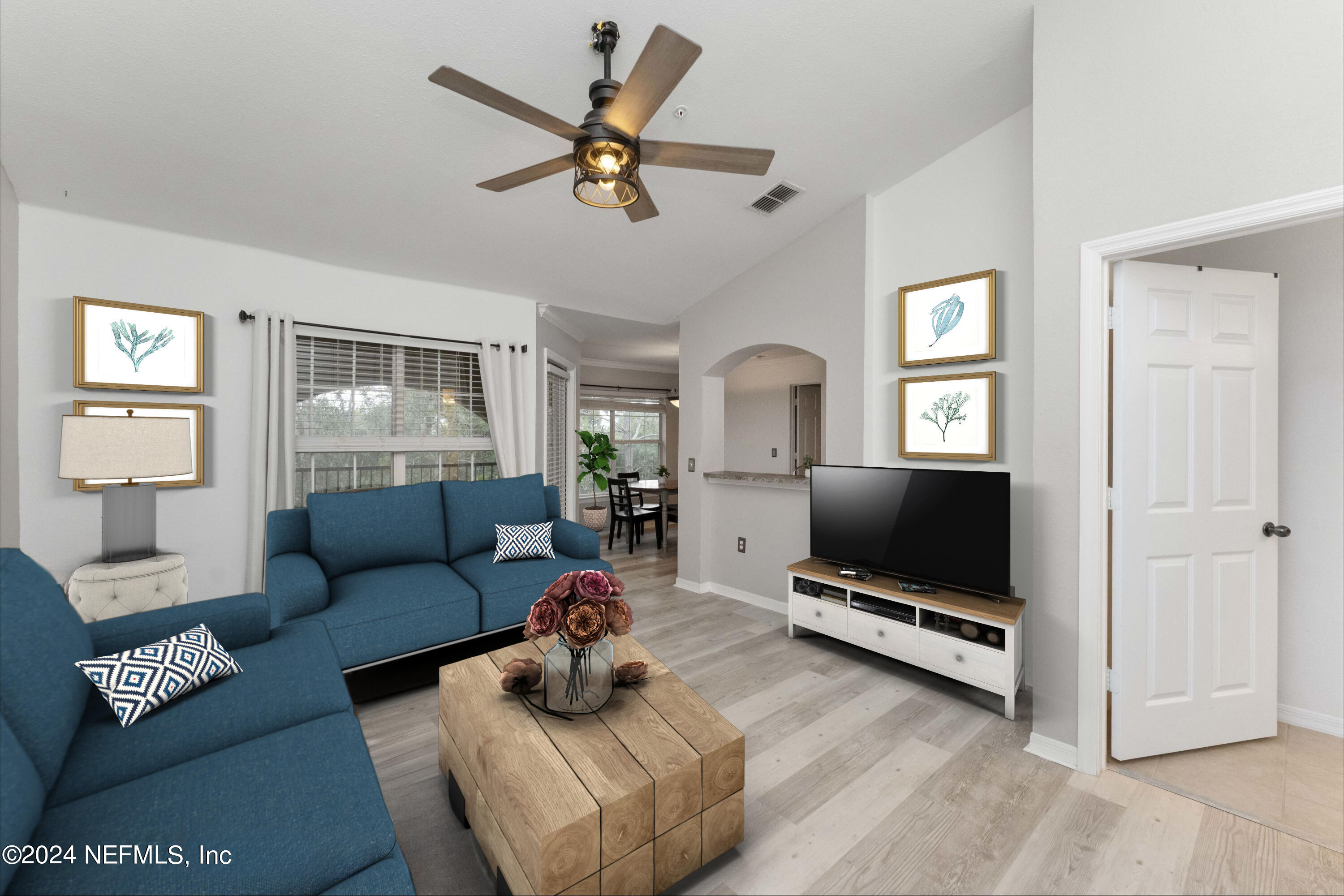 a living room with furniture and a flat screen tv