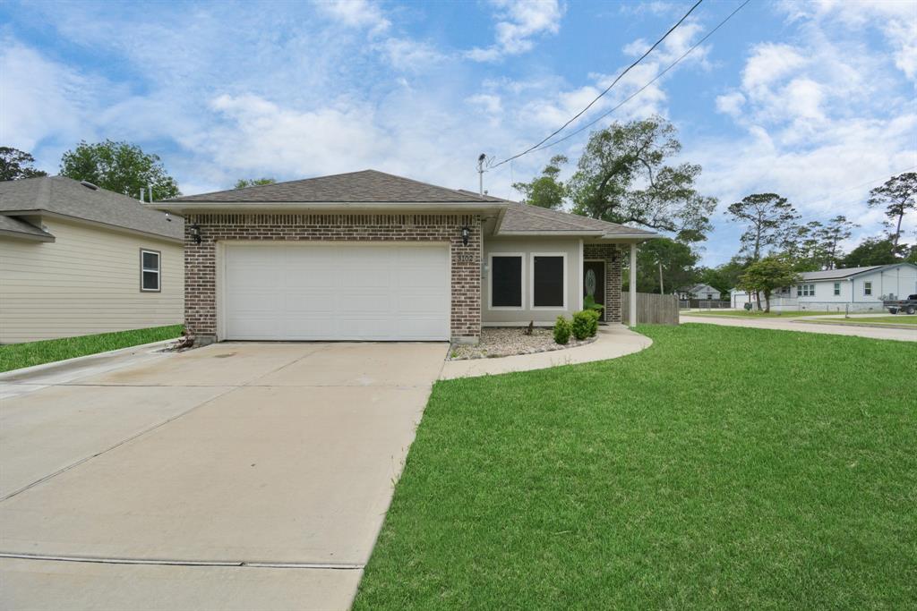 a front view of house with yard and outdoor seating