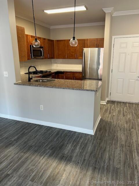 a kitchen with kitchen island granite countertop wooden floors and a sink