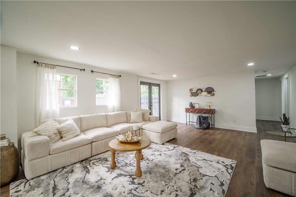 a living room with furniture and wooden floor