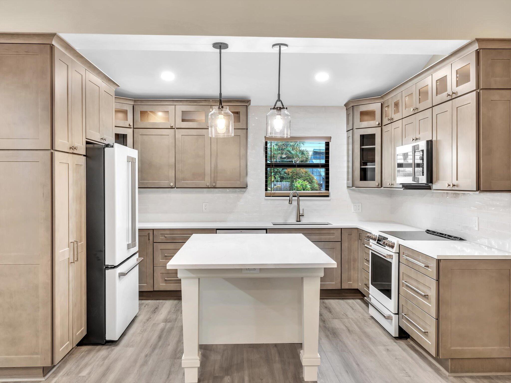 a kitchen with a sink stove and refrigerator