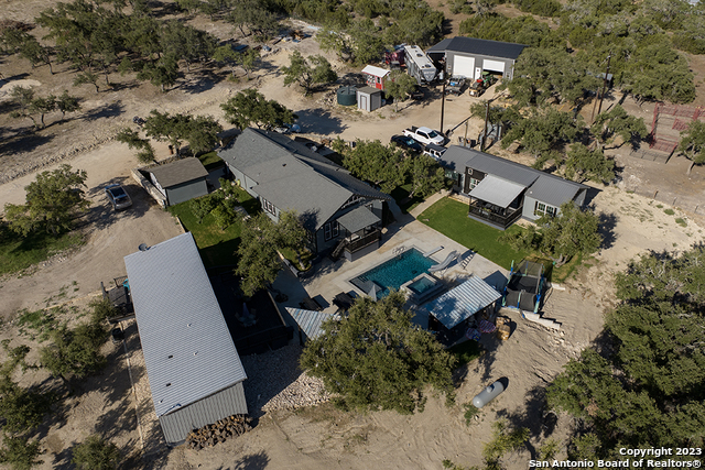 an aerial view of a house with a yard