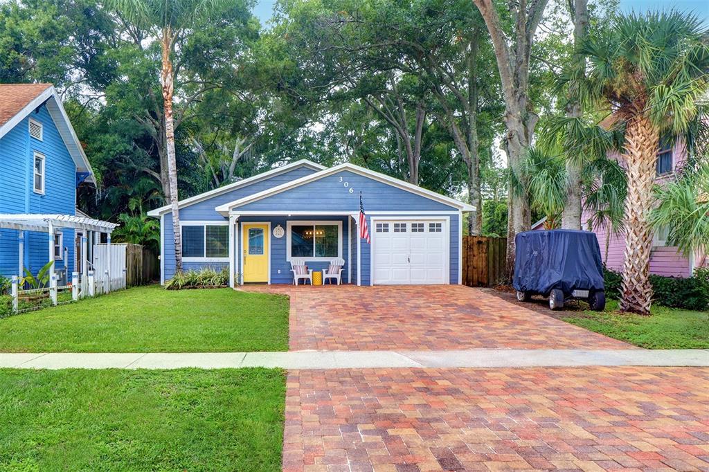 a front view of a house with yard porch and green space