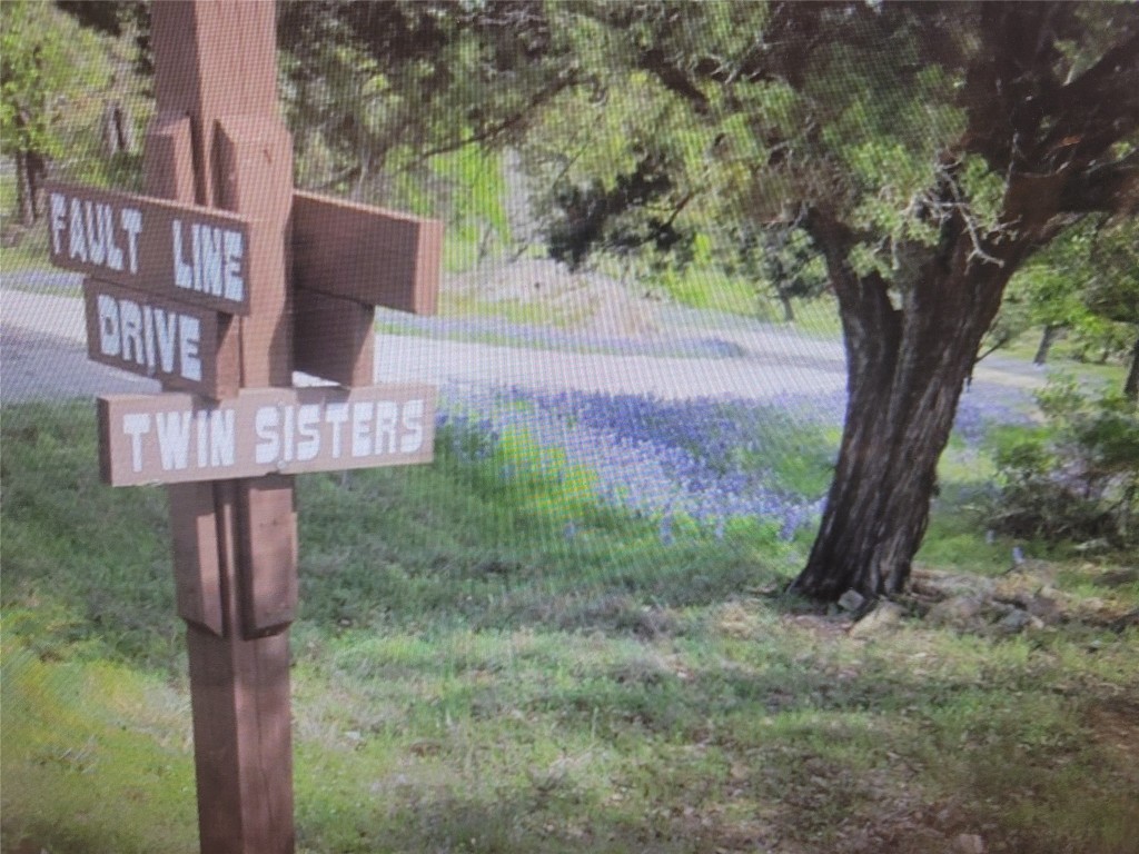 a sign board with tall trees