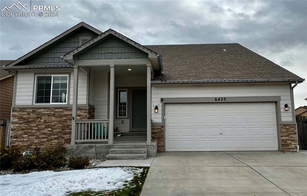 a front view of a house with garage