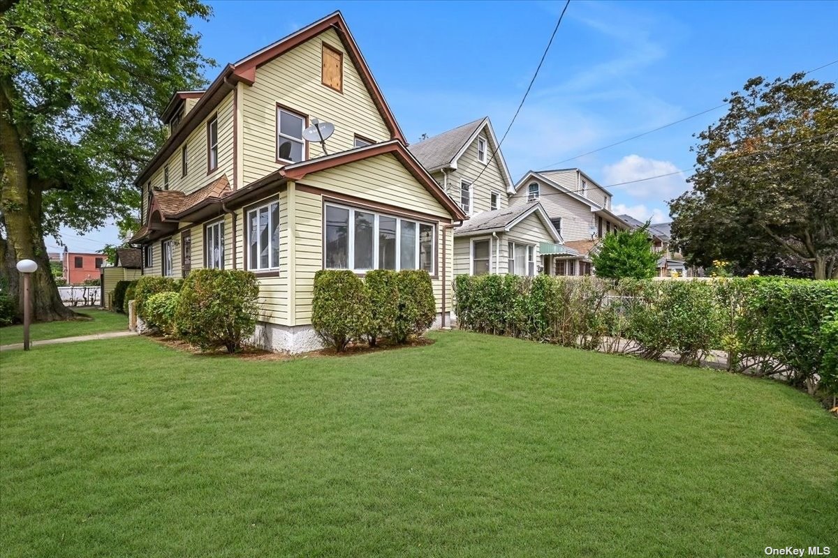 a front view of a house with a garden